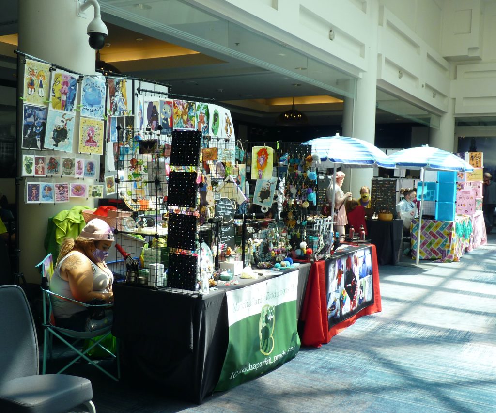 Tables and merchandise for the artist alley