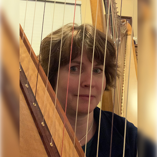 Jen Midkiff behind harp strings